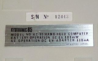 The name tag identifies the machine and includes information on the proper AC adapter to use.  Just above it is the serial number sticker.